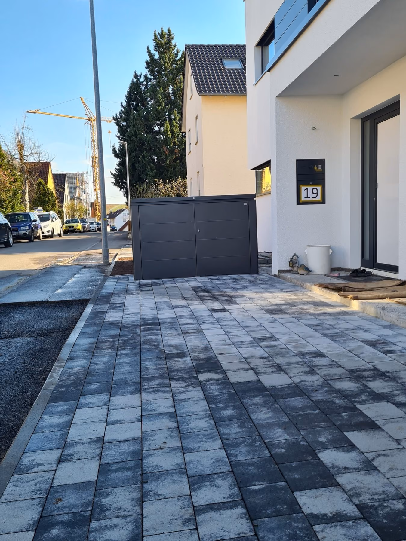 Neu gepflasterte Einfahrt eines Neubaus in der Abenddämmerung